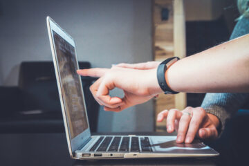 Person pointing at laptop screen. Photo by John Schnobrich on Unsplash